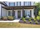 Inviting front porch with dark columns, fresh landscaping, and bench seating at 841 Keystone Dr, Woodstock, GA 30188