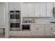 Modern kitchen boasts stainless steel appliances, stone countertops, white cabinets and lots of storage space at 841 Keystone Dr, Woodstock, GA 30188