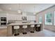 Modern kitchen featuring a large island with seating, stainless steel appliances, and ample natural light at 841 Keystone Dr, Woodstock, GA 30188