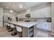 Spacious kitchen boasts a large island with seating, stainless steel appliances, pendant lighting and bright finishes at 841 Keystone Dr, Woodstock, GA 30188