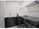 This laundry room boasts a sink, dark cabinets, and new model washer and dryer, offering convenience and efficiency at 841 Keystone Dr, Woodstock, GA 30188