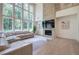 Open-concept living room with fireplace, large windows, and view of upstairs loft at 841 Keystone Dr, Woodstock, GA 30188