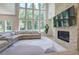 Living room featuring fireplace, stone accent wall, and large windows with wooded views at 841 Keystone Dr, Woodstock, GA 30188