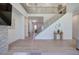 Bright living room boasts natural light, wood floors, staircase and decorative elements creating an open and inviting space at 841 Keystone Dr, Woodstock, GA 30188
