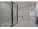 Bright main bathroom featuring a modern tub and shower with marble tile at 841 Keystone Dr, Woodstock, GA 30188