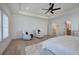 Bright main bedroom with white walls, wood floors, ceiling fan, and sitting area at 841 Keystone Dr, Woodstock, GA 30188