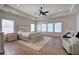 Relaxing main bedroom features natural light, tray ceilings, and hardwood floors at 841 Keystone Dr, Woodstock, GA 30188