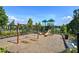 Community playground featuring swings and a slide, all surrounded by mature trees and blue skies at 841 Keystone Dr, Woodstock, GA 30188