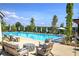 This outdoor pool area features lounge chairs with umbrellas and seating arrangements, perfect for relaxation and socializing at 841 Keystone Dr, Woodstock, GA 30188