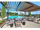This pool patio is ready for entertaining with modern seating, a large dining table, and stunning views of the pool at 841 Keystone Dr, Woodstock, GA 30188
