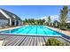 Enjoy this outdoor pool with lounge chairs and tables for relaxation, alongside a charming pool house, all set under a sunny sky at 841 Keystone Dr, Woodstock, GA 30188