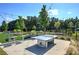 Outdoor recreation area with ping pong table, picnic tables, and play area near lush, mature trees at 841 Keystone Dr, Woodstock, GA 30188