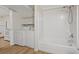 Bathroom with a combined laundry area, featuring a tub, washer, and dryer at 303 Nottingham Dr, Woodstock, GA 30188