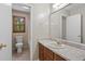 Bathroom featuring a single sink vanity with a large mirror and a window for natural light at 303 Nottingham Dr, Woodstock, GA 30188