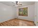 Bedroom with hardwood floors, a window, and a ceiling fan at 303 Nottingham Dr, Woodstock, GA 30188