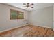 Bedroom with hardwood floors, a window, and plain white walls at 303 Nottingham Dr, Woodstock, GA 30188