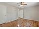 Bedroom with hardwood floors, ceiling fan, closet, and a door at 303 Nottingham Dr, Woodstock, GA 30188