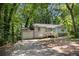 Charming single-story home with a welcoming front porch and driveway at 303 Nottingham Dr, Woodstock, GA 30188
