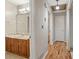 Hallway featuring wood-look floors and access to the bathroom with a vanity at 303 Nottingham Dr, Woodstock, GA 30188