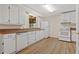 Bright kitchen featuring white cabinets, a window, and modern appliances at 303 Nottingham Dr, Woodstock, GA 30188