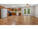 Functional kitchen and living area with wood floors, appliances, and double doors at 303 Nottingham Dr, Woodstock, GA 30188