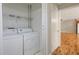 Laundry area with washer and dryer hookups, next to the door leading to a room with hardwood floors at 303 Nottingham Dr, Woodstock, GA 30188