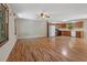 Bright living room with wood flooring and kitchen with appliances at 303 Nottingham Dr, Woodstock, GA 30188