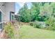 Large backyard with mature trees and a storage shed at 312 Sierra Ct, Mcdonough, GA 30253