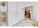 Bathroom with a tiled shower, double closets, and views into the main bedroom at 312 Sierra Ct, Mcdonough, GA 30253
