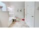 All-white bathroom featuring a soaking tub and a separate walk-in shower at 312 Sierra Ct, Mcdonough, GA 30253