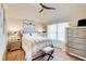 Bright bedroom featuring a queen-size bed, ceiling fan, and a mirrored dresser at 312 Sierra Ct, Mcdonough, GA 30253