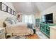 Bedroom featuring blue furniture, vaulted ceiling, and large window at 312 Sierra Ct, Mcdonough, GA 30253