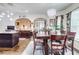 Bright dining room featuring wood floors, stylish chandelier, and an elegant table set perfect for Gathering gatherings at 312 Sierra Ct, Mcdonough, GA 30253