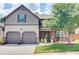 Charming two-story home with a well-manicured lawn, mature landscaping, and a two-car garage at 312 Sierra Ct, Mcdonough, GA 30253