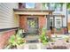 Inviting front porch with brick accents, decorative plants, and a welcoming wreath on the front door at 312 Sierra Ct, Mcdonough, GA 30253