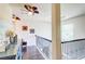 Upstairs hallway with hardwood floors, decor, and natural light from a large window at 312 Sierra Ct, Mcdonough, GA 30253
