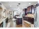 Spacious kitchen with dark cabinets, granite countertops, a central island, and stainless steel appliances at 312 Sierra Ct, Mcdonough, GA 30253