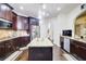 Gourmet kitchen features dark cabinets, a granite-topped island, and modern stainless steel appliances at 312 Sierra Ct, Mcdonough, GA 30253