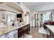 Open concept kitchen with granite counters, stainless steel appliances, and a view to the dining and living areas at 312 Sierra Ct, Mcdonough, GA 30253
