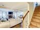 Bright, open living room with a fireplace, and hardwood floors that flow into a staircase at 312 Sierra Ct, Mcdonough, GA 30253