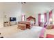 Bright main bedroom with vaulted ceiling, seating area, and modern decor at 312 Sierra Ct, Mcdonough, GA 30253