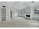 Unfinished living room featuring abundant natural light, a fireplace, and an open design at 60 Linton St, Woodstock, GA 30188