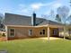 Home with a textured exterior wall and covered patio space overlooking a large yard at 3402 Milan Ct # 1 Plapprox Sqft 2, Douglasville, GA 30135