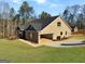 Exterior view of a brick home with a large, attached, covered garage and a manicured lawn at 3402 Milan Ct # 1 Plapprox Sqft 2, Douglasville, GA 30135
