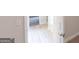 Open hallway transition with light wood flooring connecting living areas and a bedroom at 3402 Milan Ct # 1 Plapprox Sqft 2, Douglasville, GA 30135