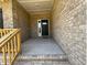 Covered front entrance with brick walls, stairs, and a black front door at 3402 Milan Ct, Douglasville, GA 30135