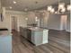 Open-concept living space with hardwood floors, kitchen with island, and dining area at 3402 Milan Ct, Douglasville, GA 30135