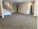 Expansive carpeted living room with stairs and doorways, perfect for entertaining at 3402 Milan Ct, Douglasville, GA 30135