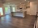 Open-concept living space with hardwood floors, kitchen with island, and dining area at 3402 Milan Ct, Douglasville, GA 30135