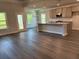Open-concept living space with hardwood floors, kitchen with island, and dining area at 3402 Milan Ct, Douglasville, GA 30135